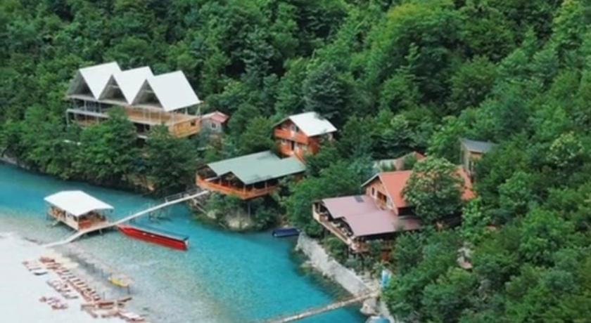Aerial perspective of Shala River boats and traditional alpine houses